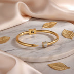 Open bangle with zirconia detail.