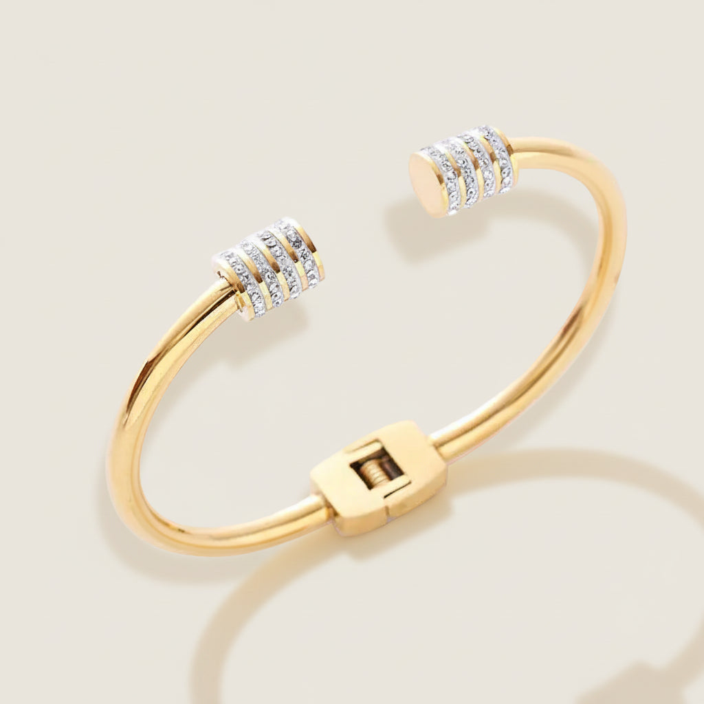 Open bangle bracelet with zirconia accents.