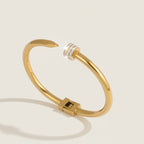 Open bangle with zirconia detail.
