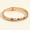 18K Gold Plated Bangle with Blue Eye Motifs and Zirconia Accents